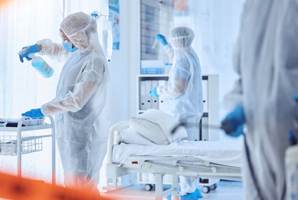 Biohazard team cleaning a medical hospital. Csi team in hazmat suits cleaning a protected quarantin